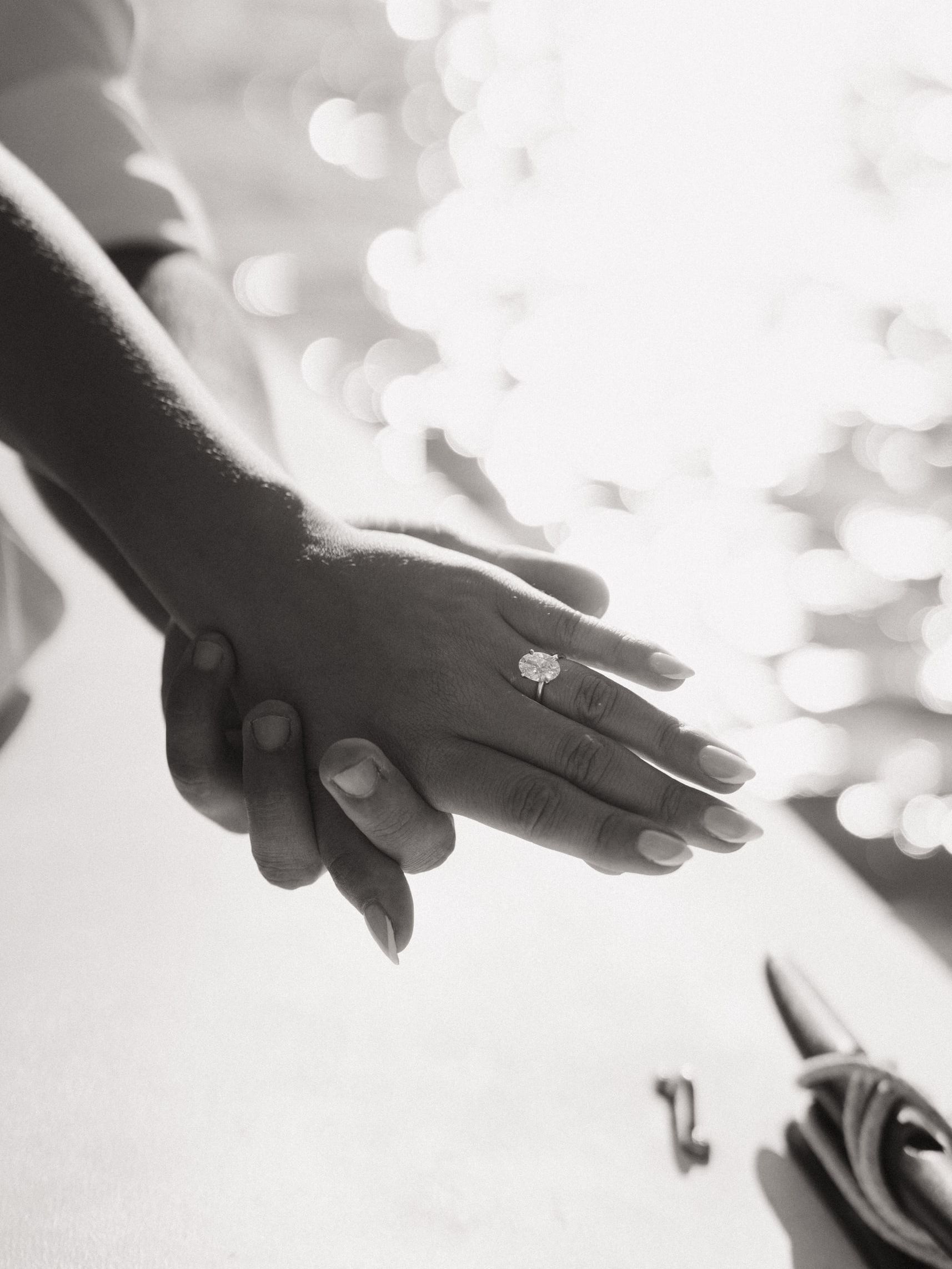 Julie’s ring, hands held, light on the water